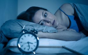Woman laying in bed who can't sleep